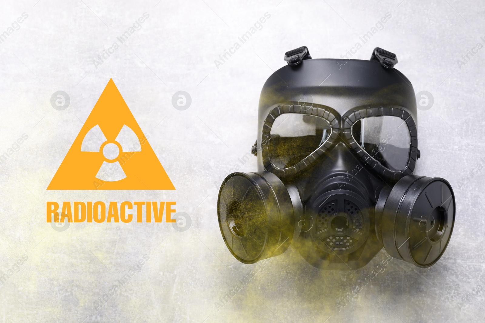 Image of Radiation threat. Gas mask, radioactive sign and smoke on grey background, top view