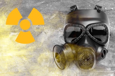Image of Radiation threat. Gas mask, radioactive sign and smoke on grey background, top view