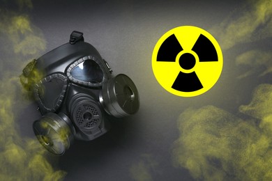 Image of Radiation threat. Gas mask, radioactive sign and smoke on grey background, top view