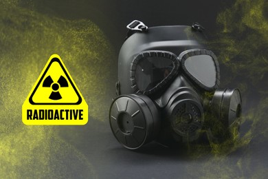 Image of Radiation threat. Gas mask, radioactive sign and smoke on grey table