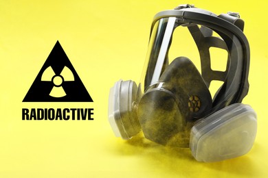 Image of Radiation threat. Gas mask, radioactive sign and smoke on yellow background