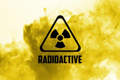 Image of Radioactive sign and yellow toxic smoke against white background
