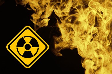 Image of Radioactive sign and yellow toxic smoke against black background