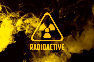 Image of Radioactive sign and yellow toxic smoke against black background