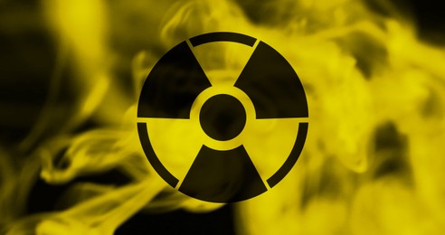 Image of Radioactive sign and yellow toxic smoke against black background. Banner design
