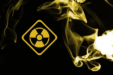 Image of Radioactive sign and yellow toxic smoke against black background