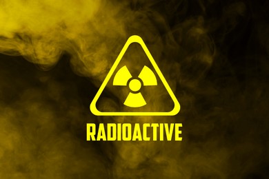 Image of Radioactive sign and yellow toxic smoke against black background