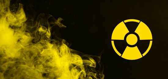 Image of Radioactive sign and yellow toxic smoke against black background. Banner design