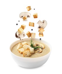 Image of Croutons and mushrooms falling into bowl of soup against white background
