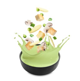 Image of Croutons, mushrooms, potato slices and green peas falling into bowl of soup against white background