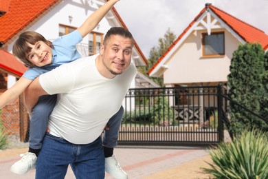Image of Father with his son near their house outdoors