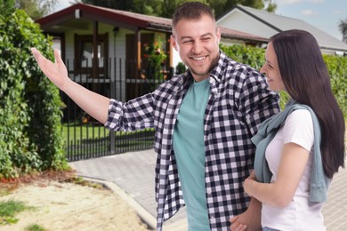 Image of Happy couple near their house outdoors. Real estate ownership