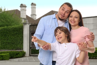 Image of Family with kid near their house outdoors