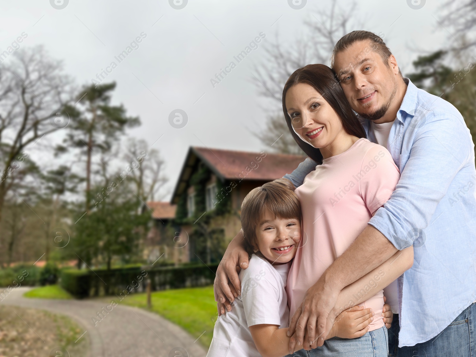 Image of Family with kid near their house outdoors