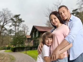 Image of Family with kid near their house outdoors