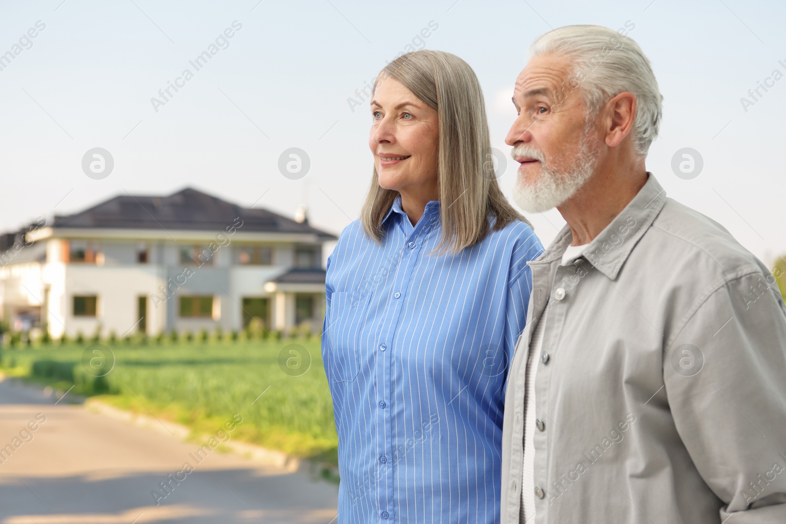 Senior couple near their house outdoors. Real estate ownership Image of Senior couple near their house outdoors. Real estate ownership