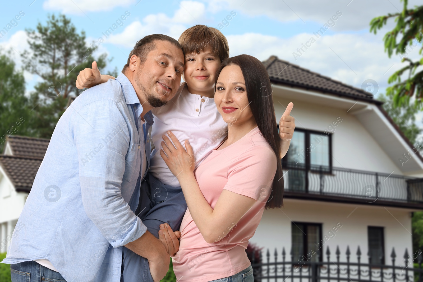 Family with kid near their house outdoors Image of Family with kid near their house outdoors