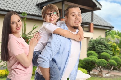 Image of Family with kid near their house outdoors