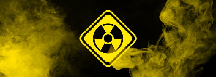 Image of Radioactive sign and yellow toxic smoke against black background. Banner design