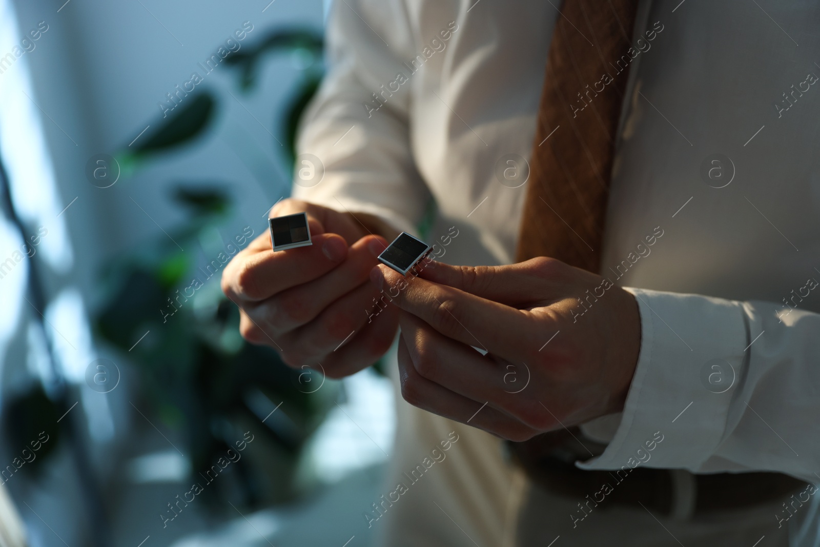 Man with cufflinks getting ready indoors, closeup. Space for text Photo of Man with cufflinks getting ready indoors, closeup. Space for text