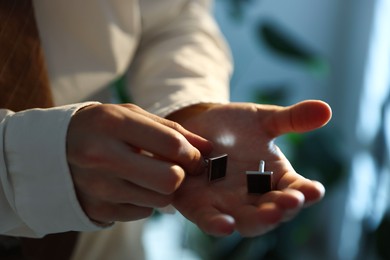 Photo of Man with cufflinks getting ready indoors, closeup