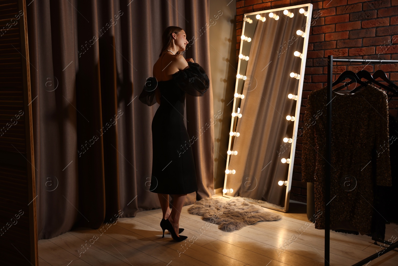 Woman brushing her hair while getting ready near mirror indoors Photo of Woman brushing her hair while getting ready near mirror indoors