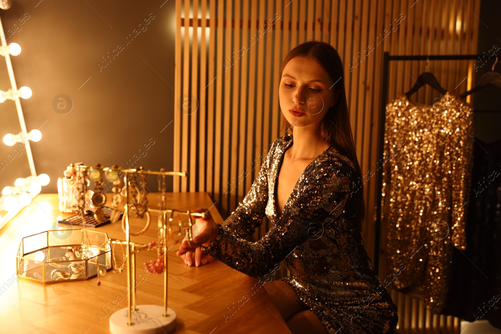 Beautiful woman getting ready at dressing table indoors Photo of Beautiful woman getting ready at dressing table indoors