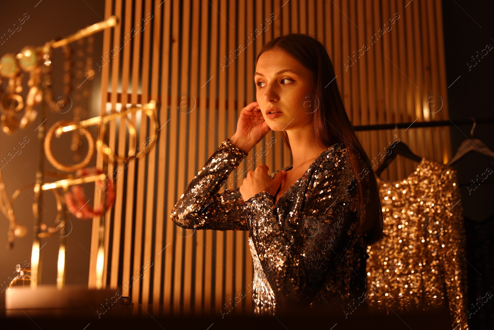 Beautiful woman getting ready at dressing table indoors Photo of Beautiful woman getting ready at dressing table indoors