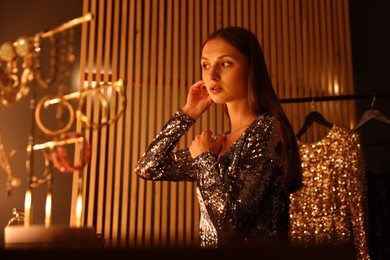 Photo of Beautiful woman getting ready at dressing table indoors