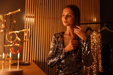 Photo of Beautiful woman getting ready at dressing table indoors