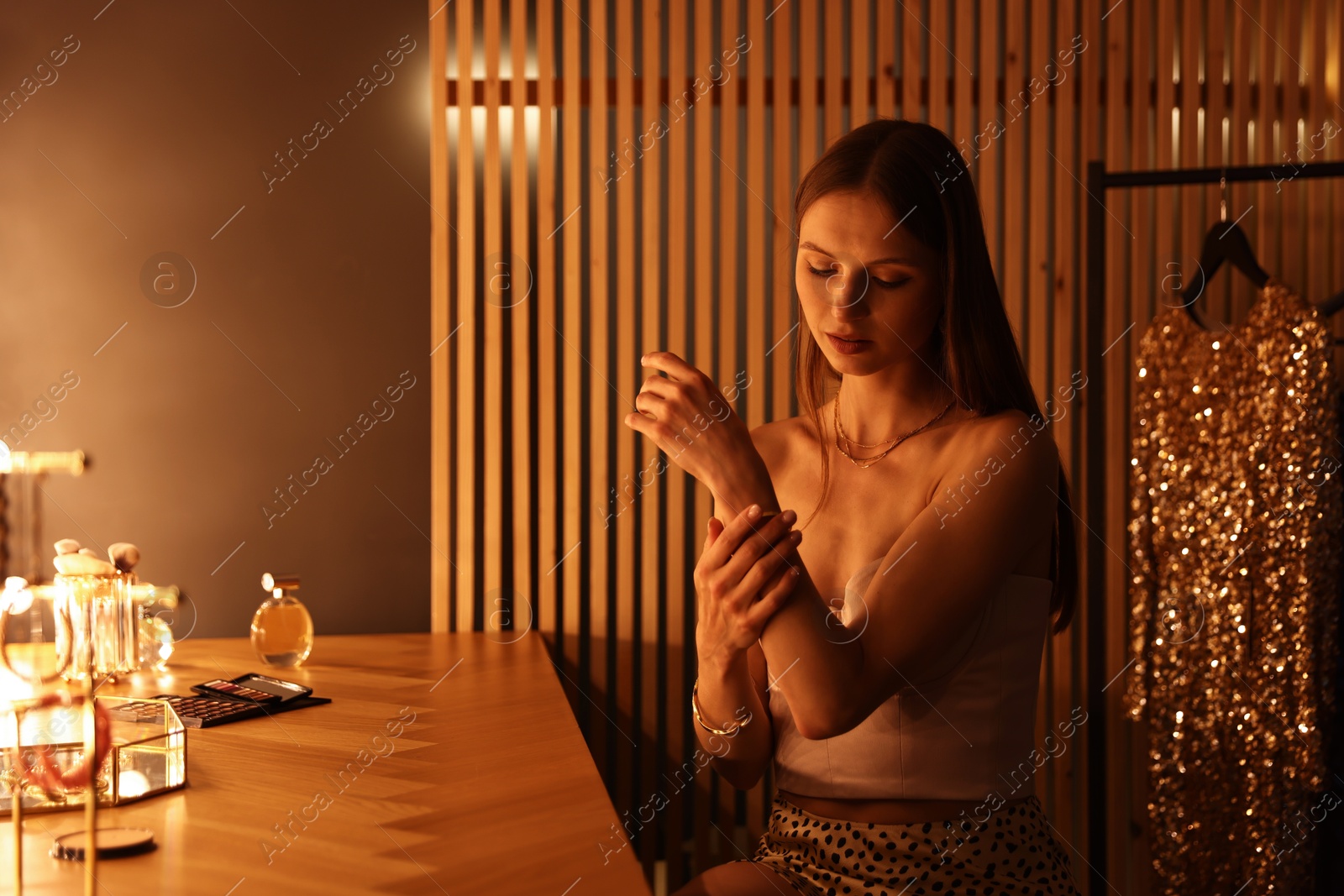 Woman wearing beautiful bracelet while getting ready at dressing table indoors Photo of Woman wearing beautiful bracelet while getting ready at dressing table indoors