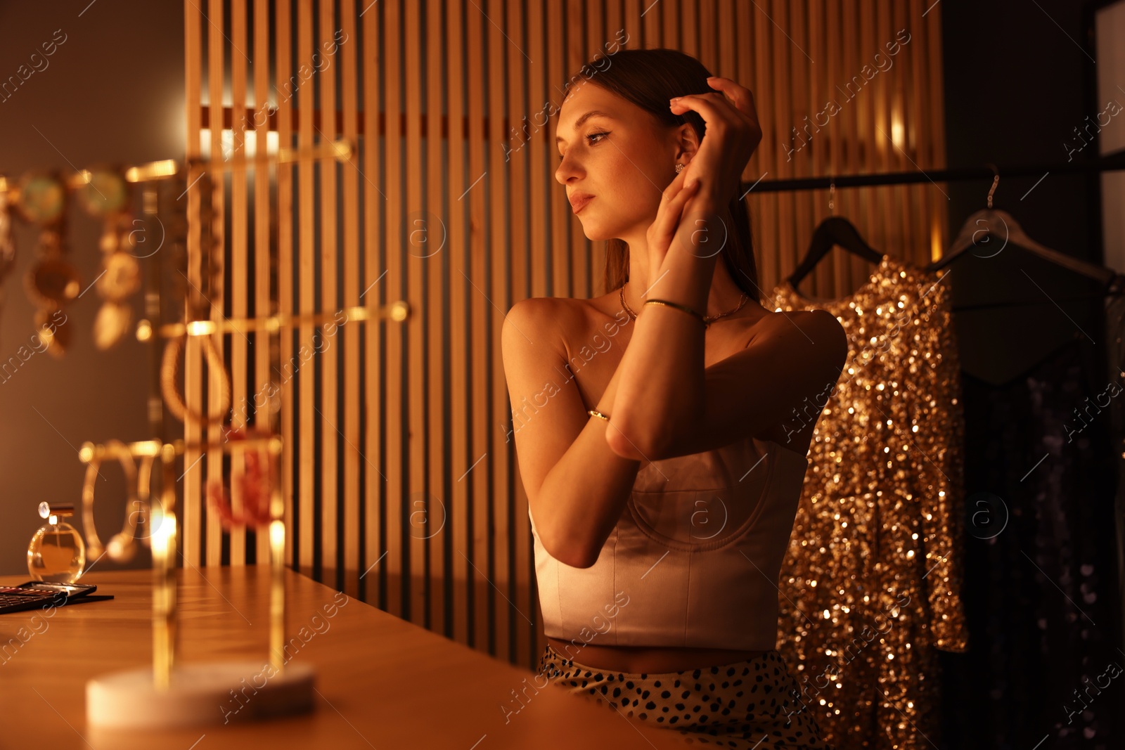 Beautiful woman getting ready at dressing table indoors Photo of Beautiful woman getting ready at dressing table indoors