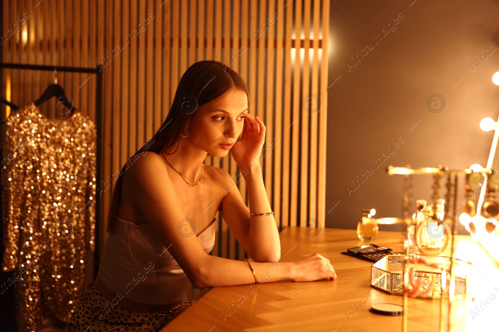 Beautiful woman getting ready at dressing table indoors Photo of Beautiful woman getting ready at dressing table indoors