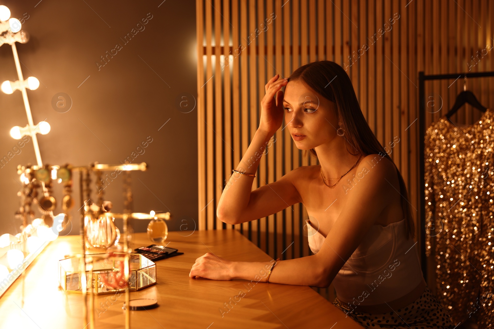 Beautiful woman getting ready at dressing table indoors Photo of Beautiful woman getting ready at dressing table indoors