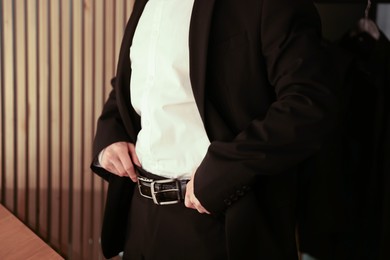 Photo of Man in elegant outfit getting ready indoors, closeup