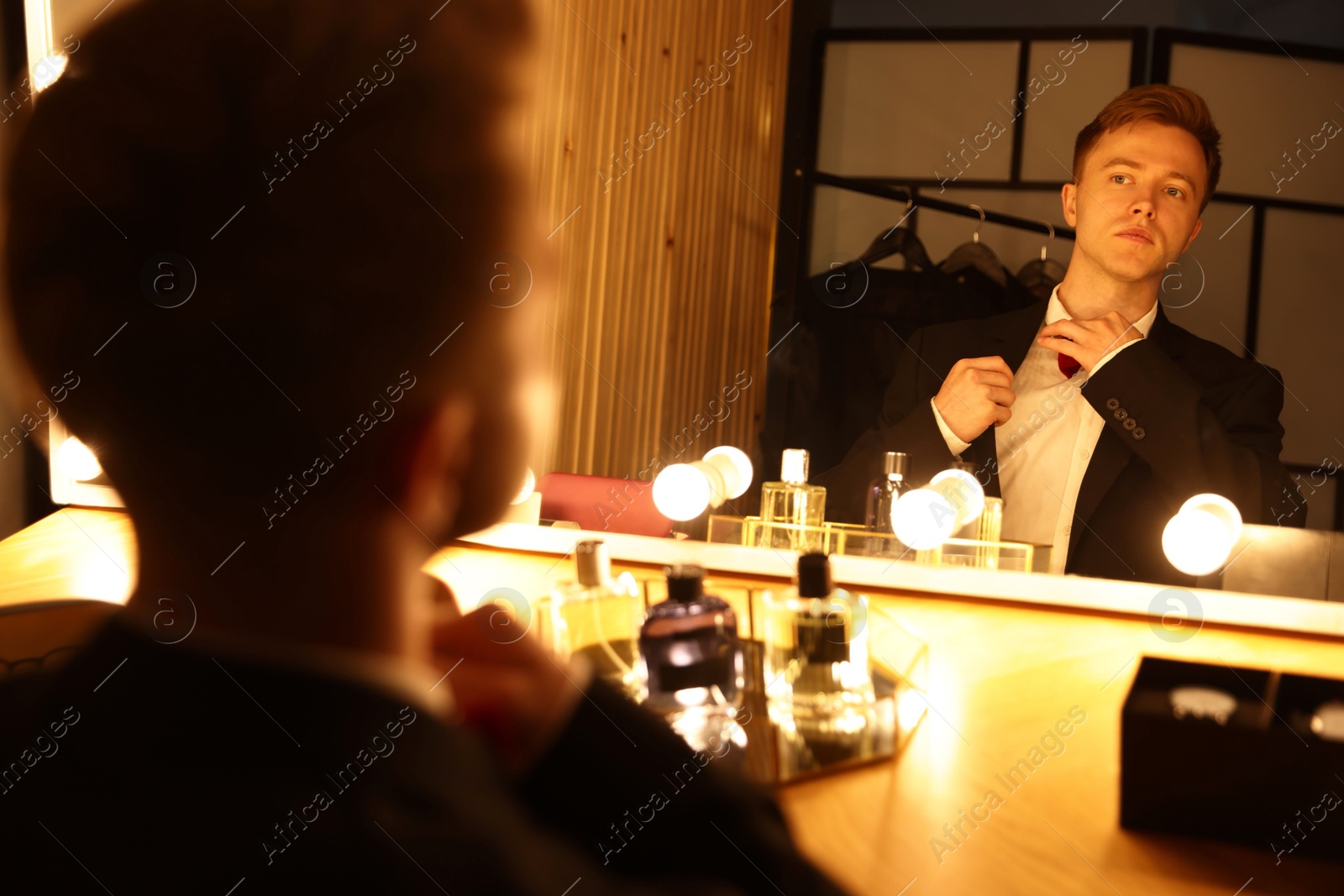 Man getting ready at dressing table indoors Photo of Man getting ready at dressing table indoors
