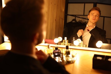 Photo of Man getting ready at dressing table indoors