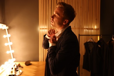 Photo of Man in stylish outfit getting ready indoors