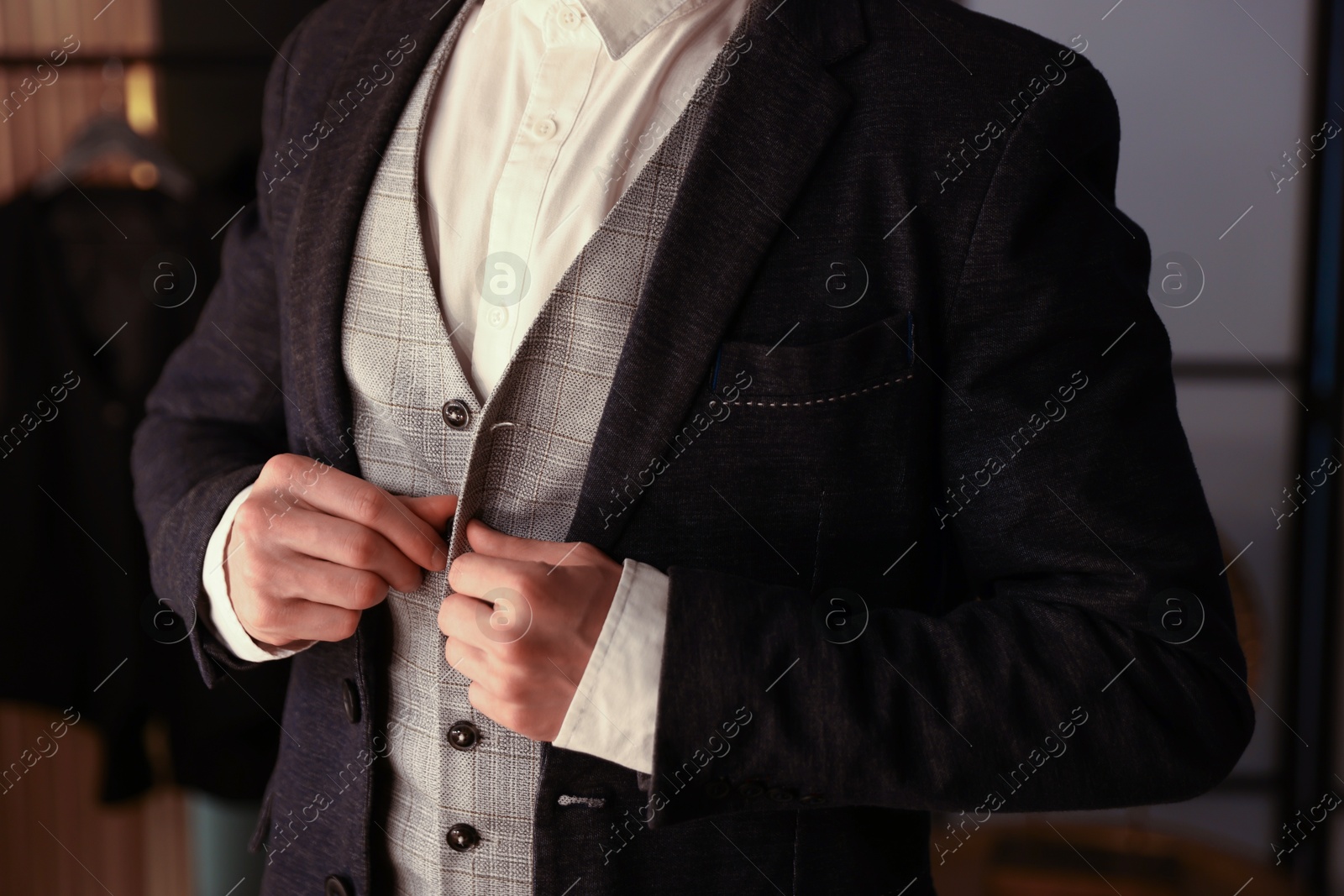 Photo of Man in stylish outfit getting ready indoors, closeup