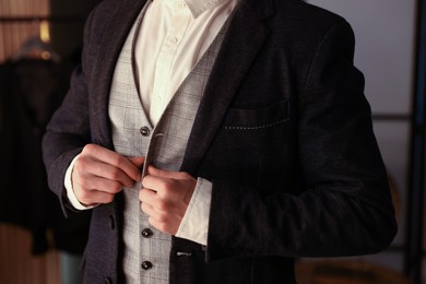 Photo of Man in stylish outfit getting ready indoors, closeup