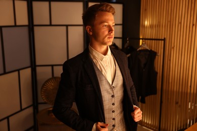 Photo of Man in stylish outfit getting ready indoors