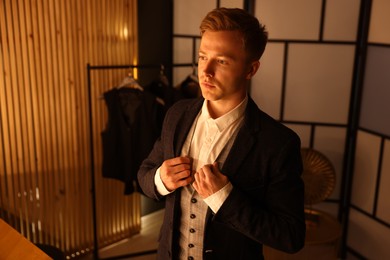 Photo of Man in stylish outfit getting ready indoors