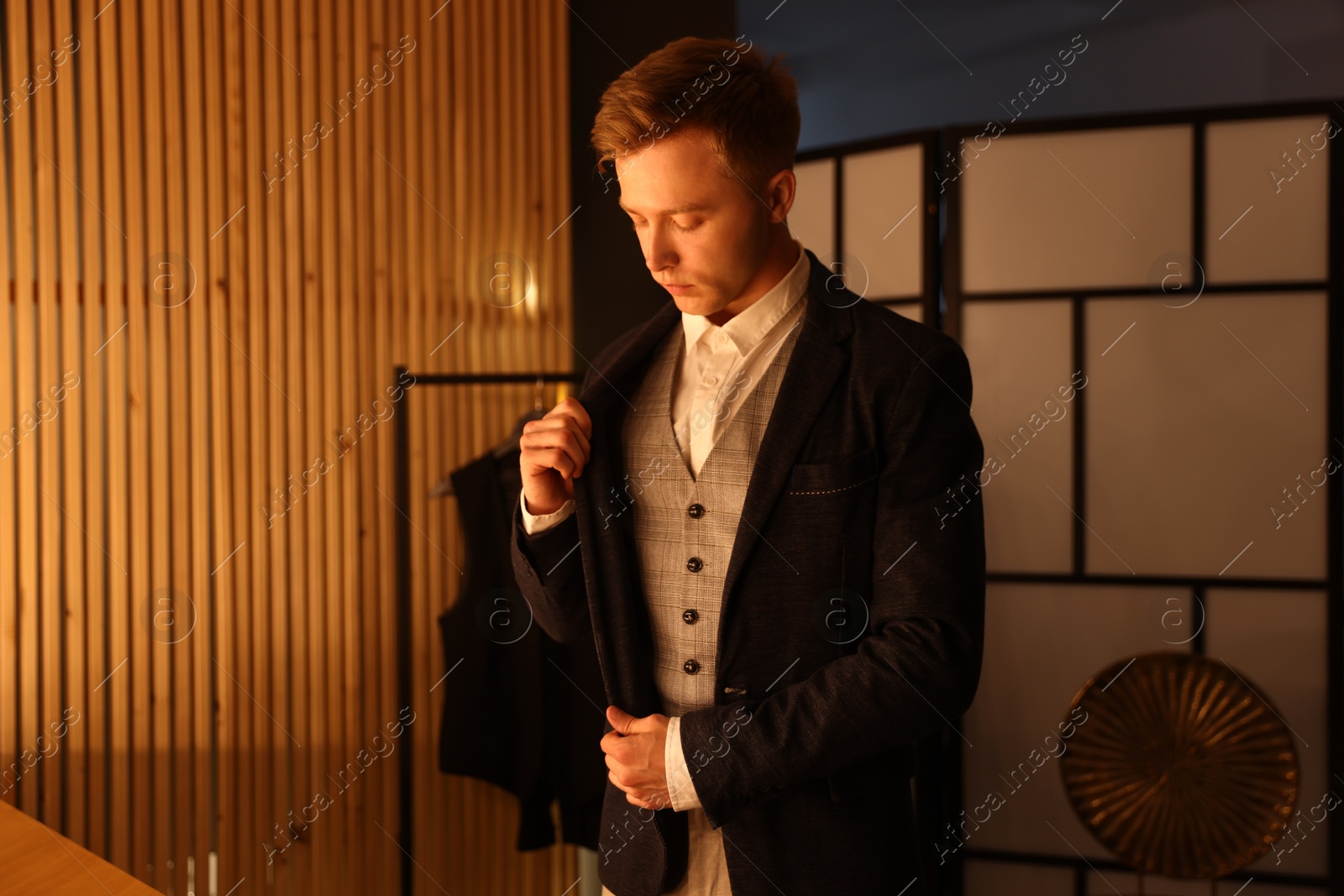 Photo of Man in stylish outfit getting ready indoors