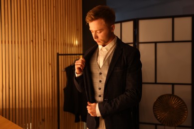 Photo of Man in stylish outfit getting ready indoors
