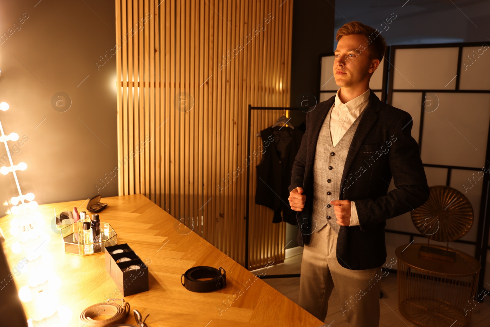 Photo of Man in stylish outfit getting ready indoors