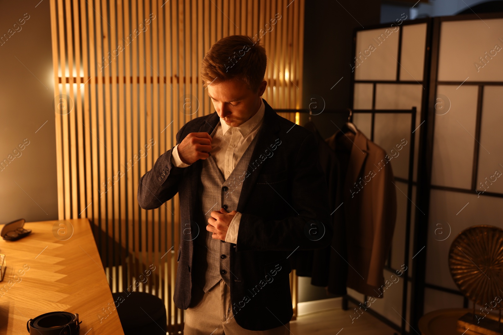 Photo of Man in stylish outfit getting ready indoors