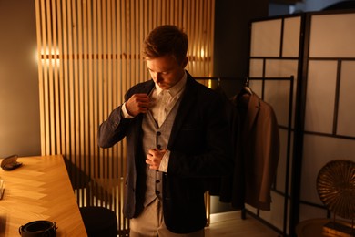Photo of Man in stylish outfit getting ready indoors