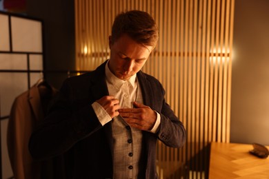 Photo of Man in stylish outfit getting ready indoors