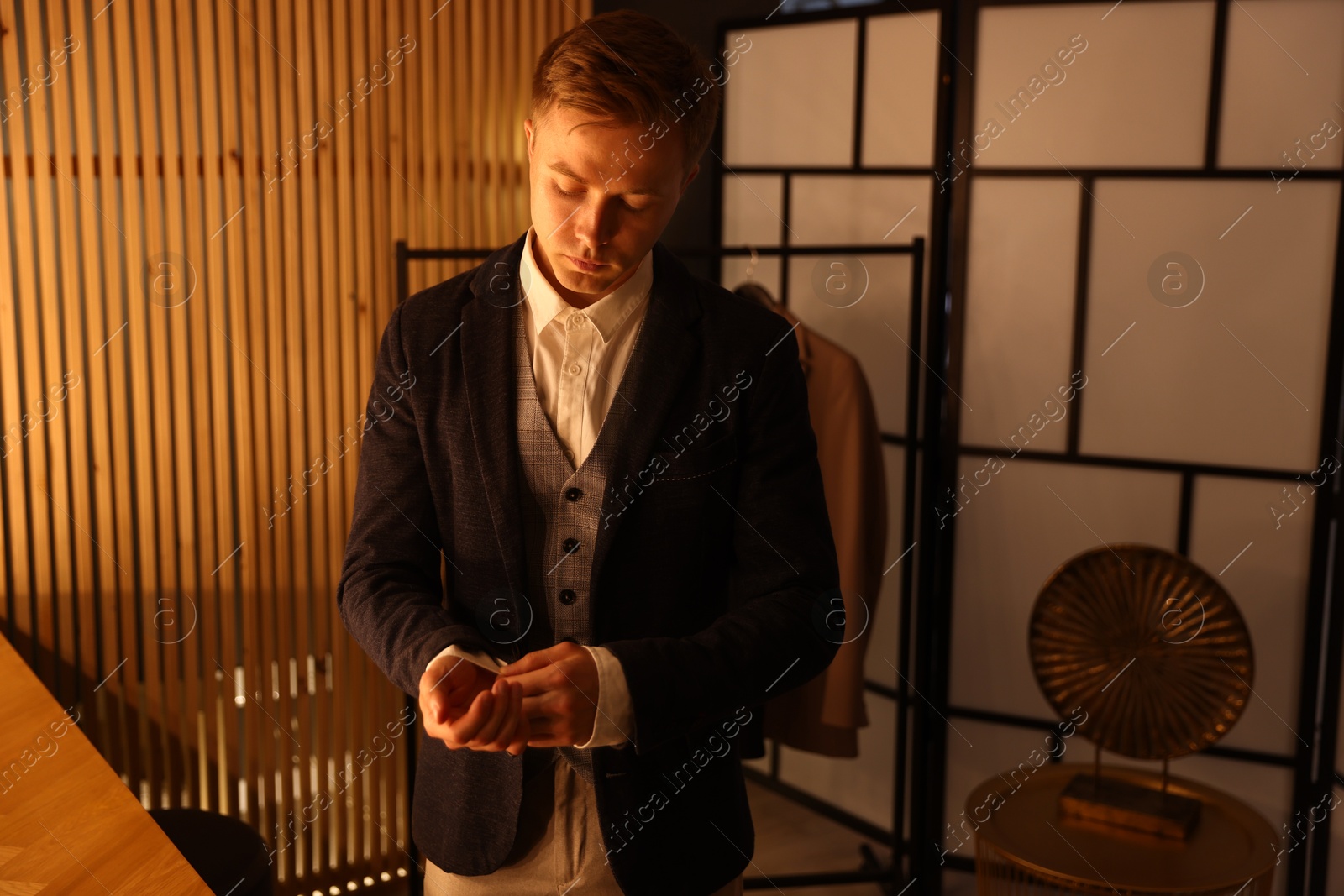 Photo of Man in stylish outfit getting ready indoors