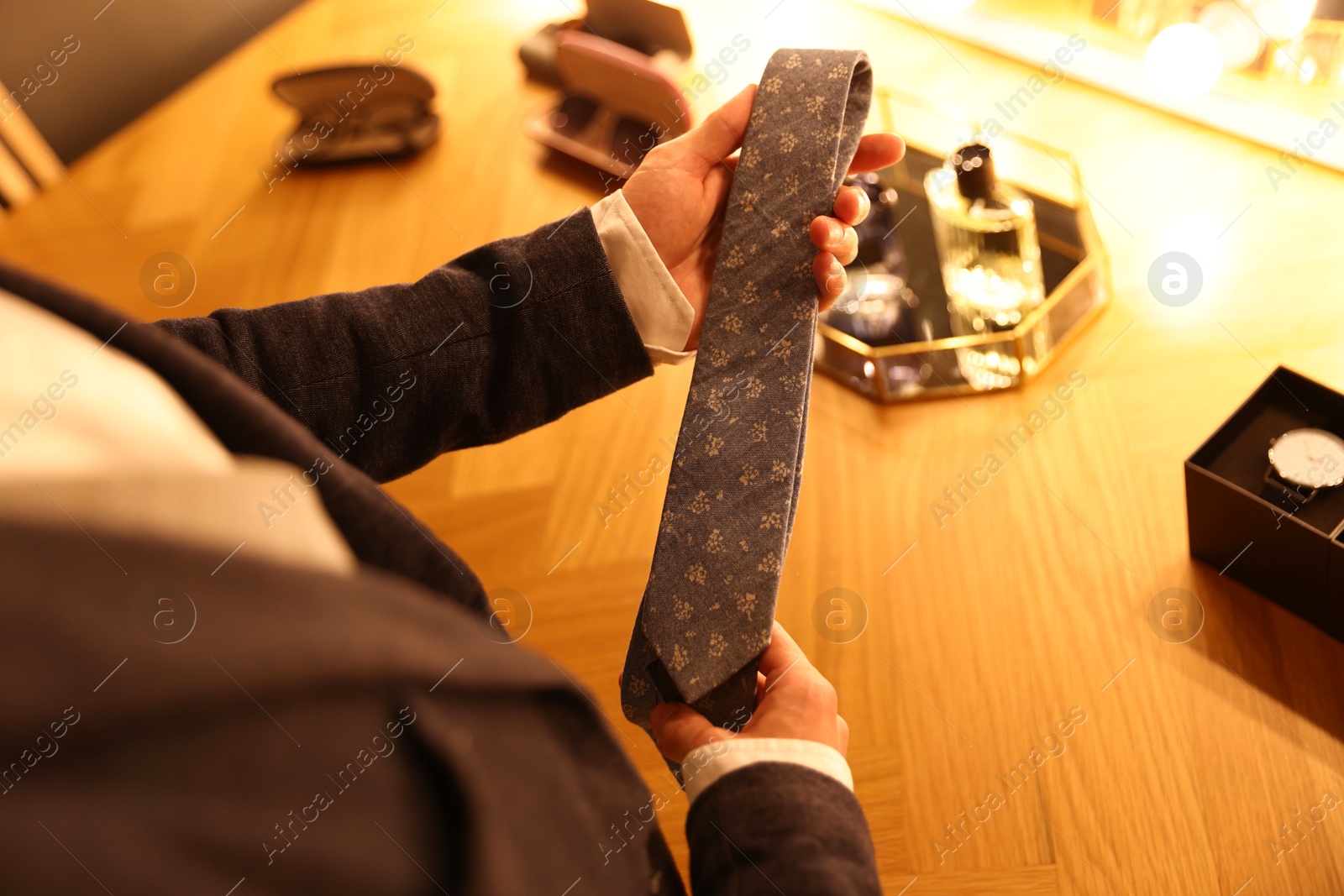 Man with necktie getting ready at dressing table indoors, above view Photo of Man with necktie getting ready at dressing table indoors, above view